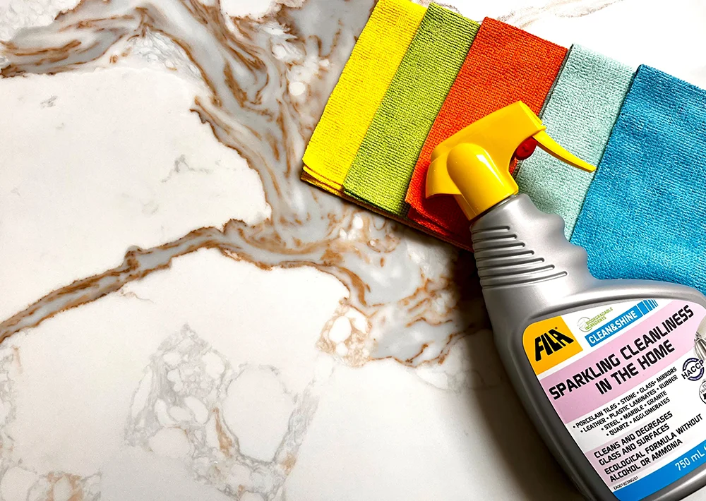 Aftercare image with clothes and cleaning product on a worksurface